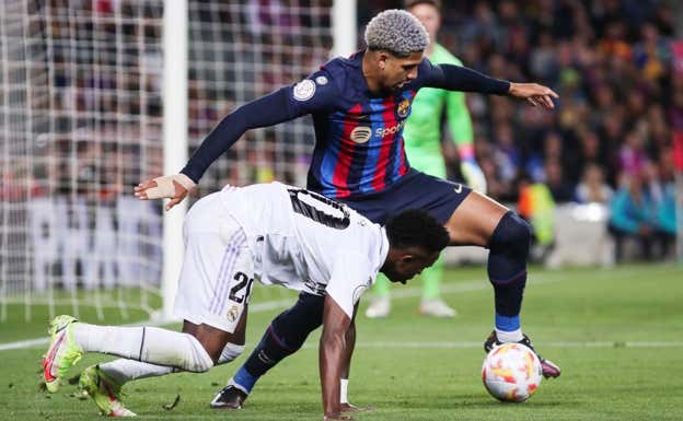 Araujo le roba un balón a Vinicius en un Clásico. AFP