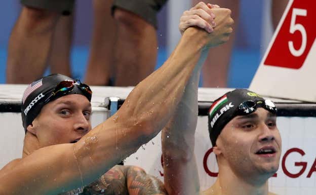 Caeleb Dressel y Kristof Milak tras su épica prueba de los 100 mariposa en Tokio 2021.  REUTERS