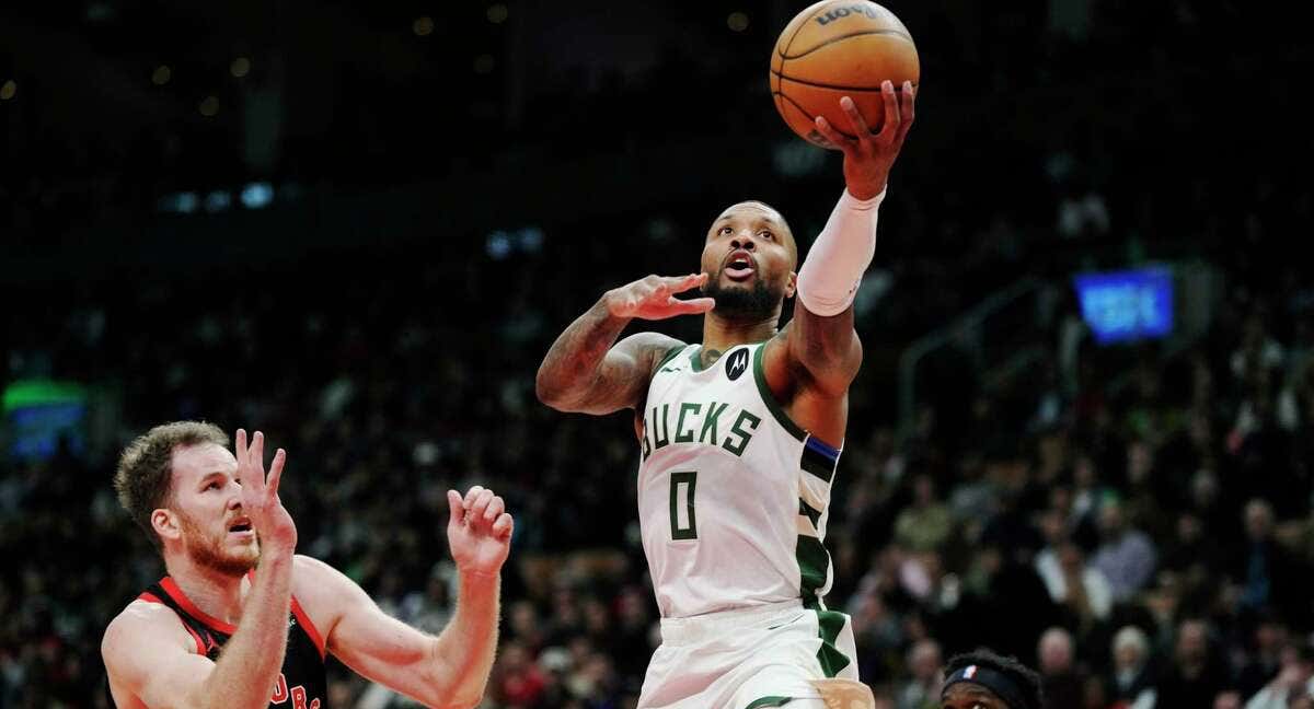 Damian Lillard trata de anotar ante la defensa de los Toronto Raptors.