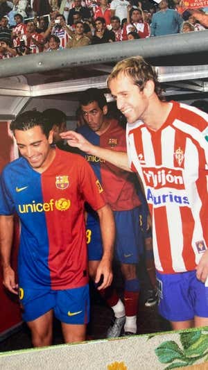 Autet salta al césped con Xavi en El Molinón.  AGENCIAS