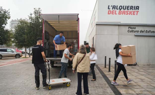 Varias personas cargan cajas con ropa y artículos de primera necesidad para las personas que se encuentran en 'La Fonteta'. GETTY