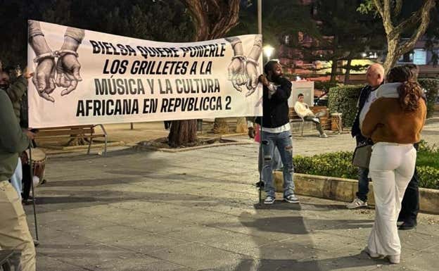 Ettien, a la derecha, portando una pancarta contra el alcalde de Mislata.